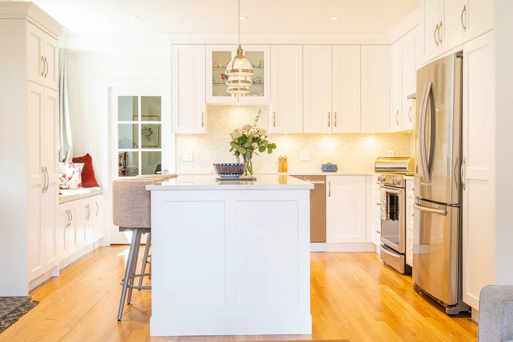 Modern white kitchen with island and appliances.